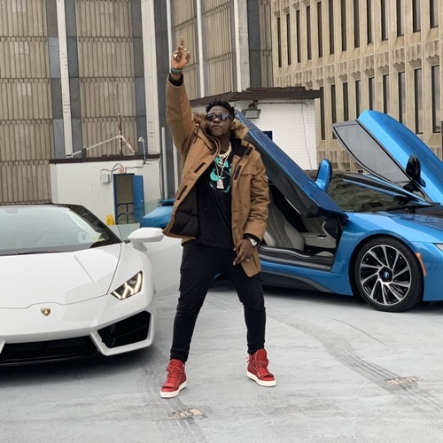 medikal davido father in front of two cars